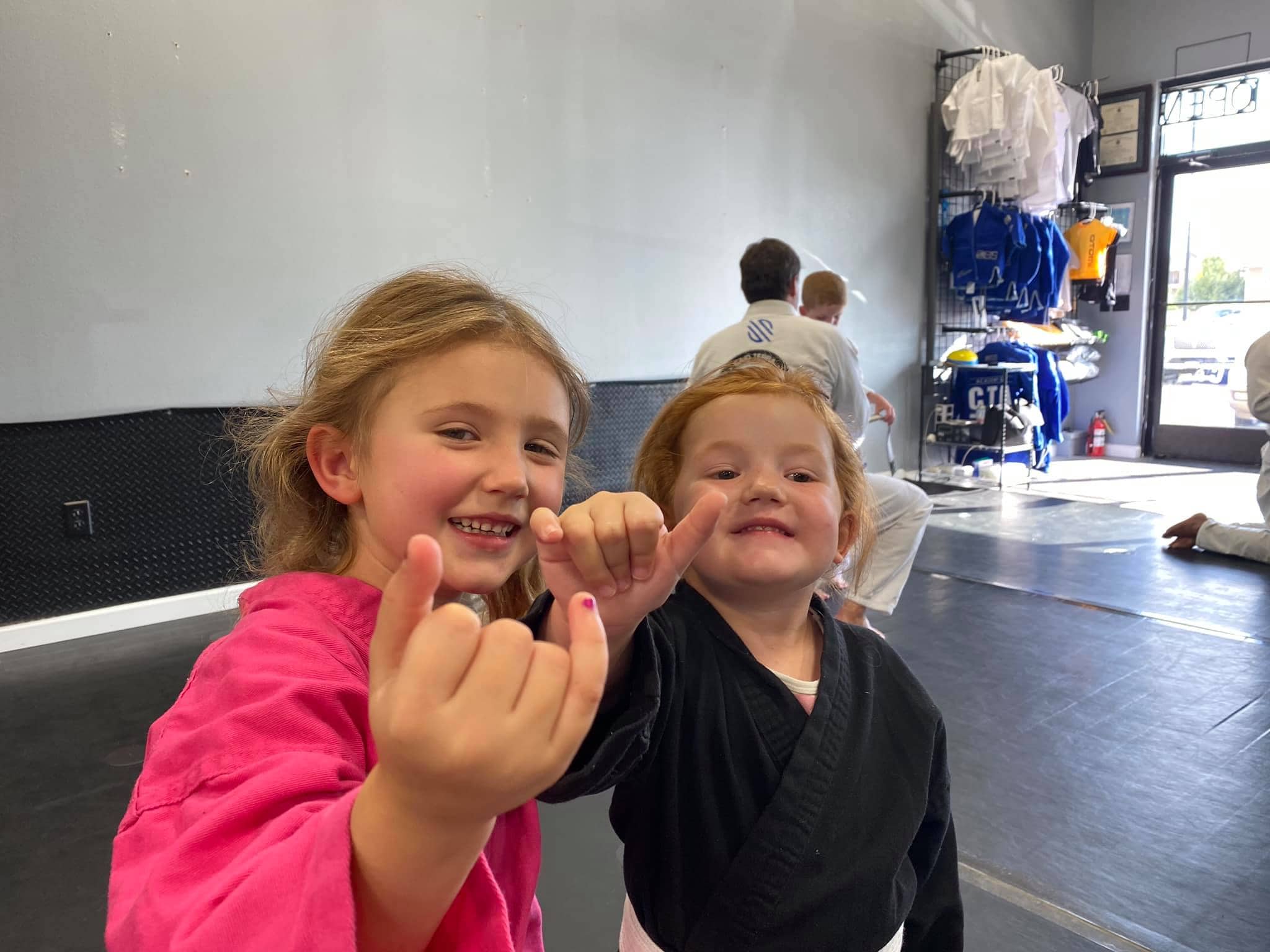 smiling kids in gi parker colorado jiu jitsu class
